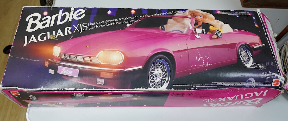 An early 1990s boxed Barbie Jaguar XJS car in pink. Condition fair to good, minor playwear and damage to the box.